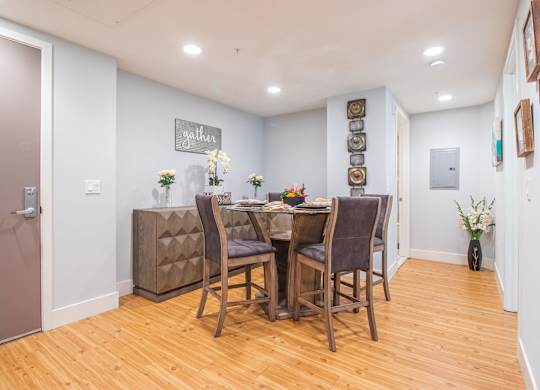 A dining room with a wooden table and chairs at Woodley Sara Apartment, Van Nuys, CA