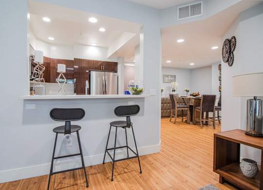 A kitchen with a bar area and a dining table at Woodley Sara Apartment, Van Nuys, California