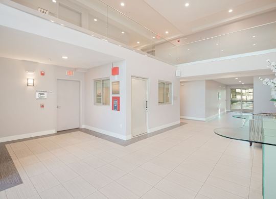 A white hallway with a glass table and chairs at Woodley Sara Apartment, Van Nuys, California