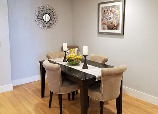 A dining room with a table set for two at Woodley Sara Apartment, Van Nuys, 91406