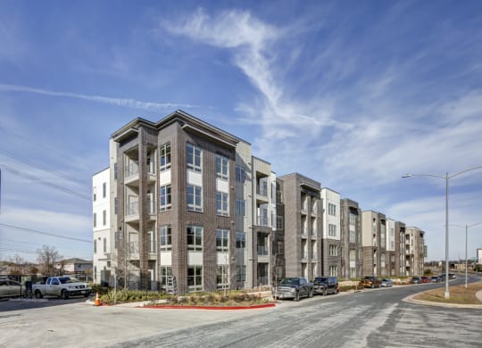 a row of apartment buildings on a city street at Arise Riverside, Austin Texas