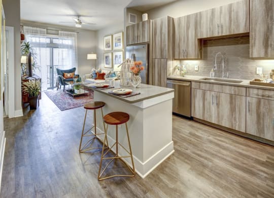 a kitchen with a center island and stools at Arise Riverside, Austin