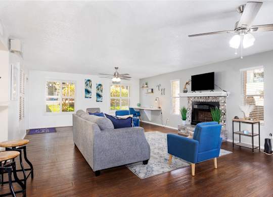 A living room with a grey couch and a blue armchair.