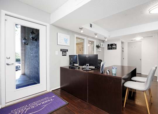A reception area with a desk and a chair.
