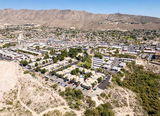 A small town with a lot of buildings and a mountain in the background.