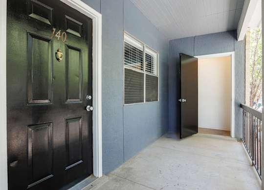 A black door with the number 140 on it.