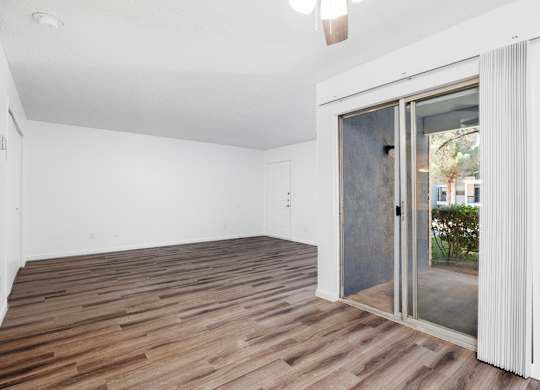 A room with a sliding glass door leading outside.