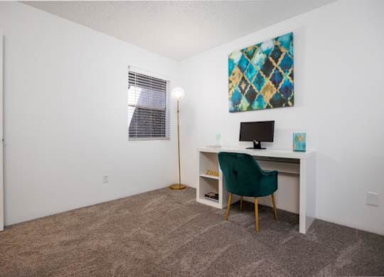 A room with a desk and a chair.