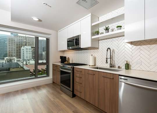 A modern kitchen with wooden cabinets and a stainless steel dishwasher.