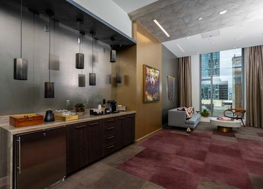 A modern kitchen with a red carpet and a stainless steel refrigerator.