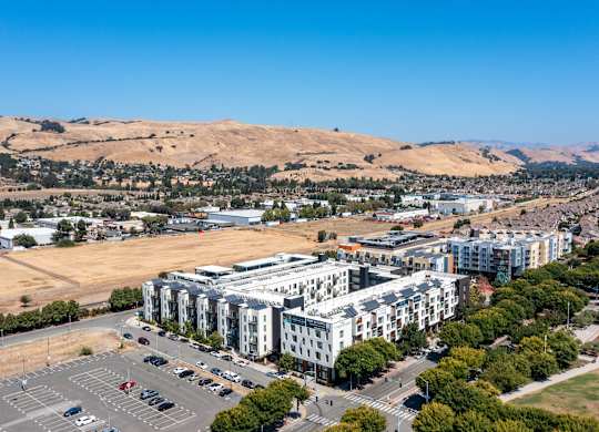 A large white building with a parking lot in front of it.