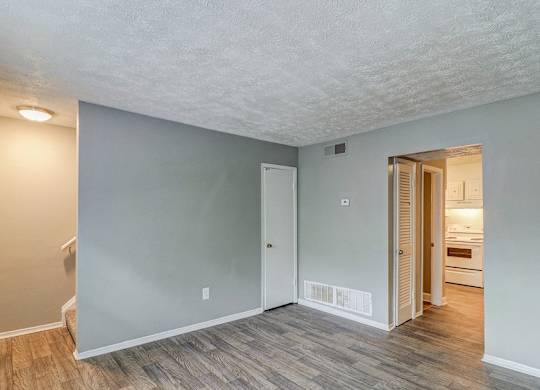 A room with a wooden floor and a white ceiling.at Waverly Manor Townhomes, Norcross, GA  