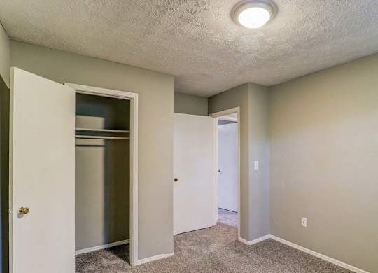 A small, empty room with a white door and a white cabinet.at Waverly Manor Townhomes, Norcross  