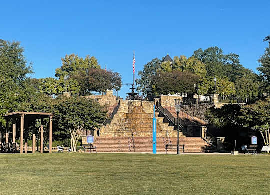 A park with a gazebo, steps, and a flag.at Waverly Manor Townhomes, Norcross, GA 30071  
