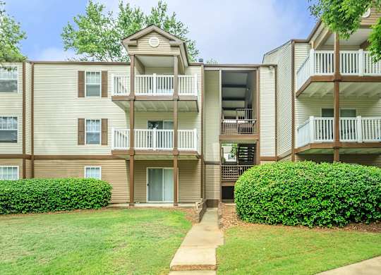 Apartment building with a green lawn in front.