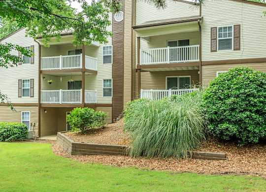 Apartment complex with a green lawn in front.