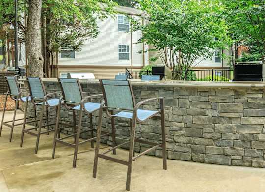 A row of chairs are lined up on a patio.