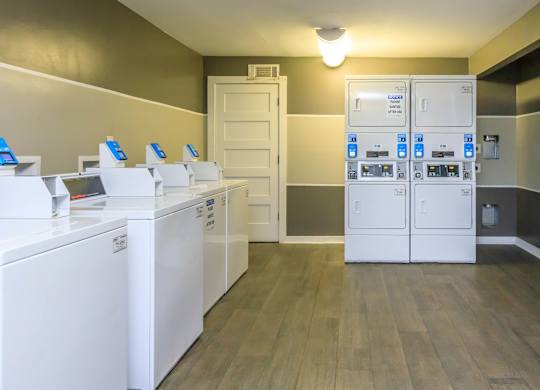A laundry room with washers and dryers.