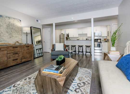 A living room with a couch, a coffee table, and a map on the wall.