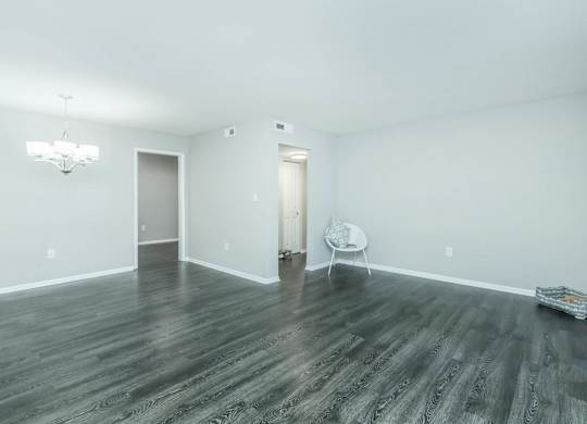 A room with a wooden floor and a white chair at Crest at East Cobb Apartments, Marietta, GA