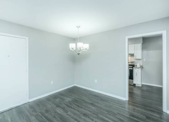 A room with a white door and a chandelier at Crest at East Cobb Apartments, Marietta, Georgia