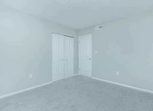 A room with two doors and carpeted floor at Crest at East Cobb Apartments, GA, 30062