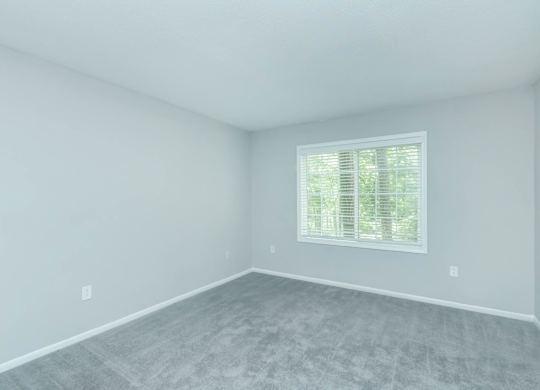A room with a window and a grey floor at Crest at East Cobb Apartments, Georgia, 30062