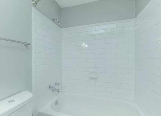 A white bathroom with a tub, toilet and shower at Crest at East Cobb Apartments, Marietta, GA