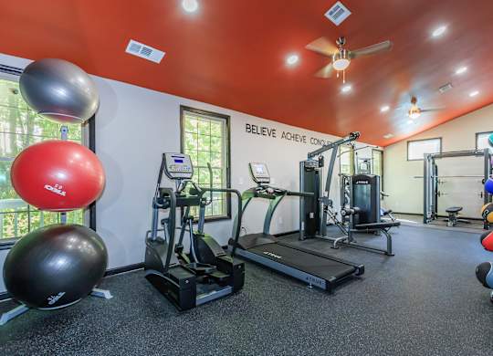 A gym with a treadmill, exercise balls, and other equipment at Crest at East Cobb Apartments, Georgia, 30062