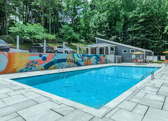 A pool with a mural on the fence at Crest at East Cobb Apartments, Marietta, GA, 30062
