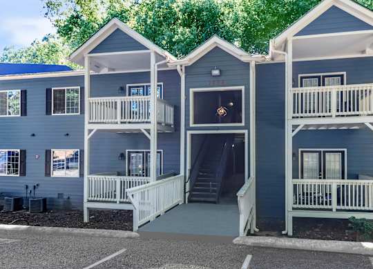 A two story house with a balcony on the second floor at Crest at East Cobb Apartments, Georgia