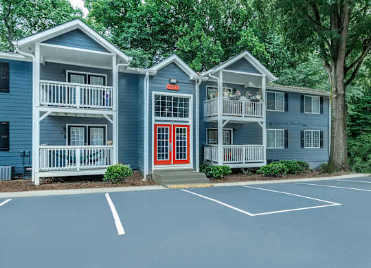 A blue building with a red door and windows at Crest at East Cobb Apartments, Georgia, 30062