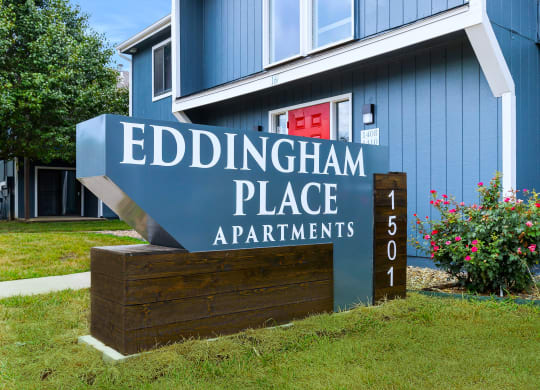 a blue building with a sign that says eddingham place apartments