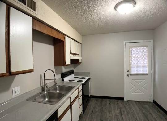 full kitchen with door and farm sink