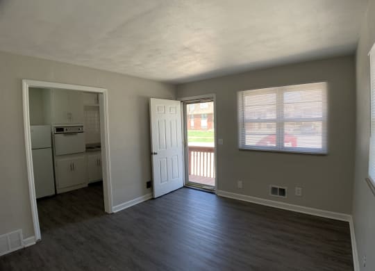 Spacious living room looking into kitchen