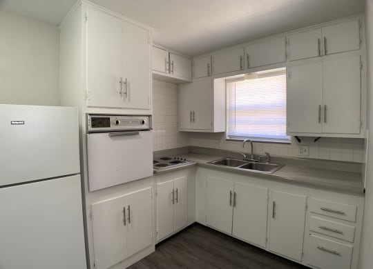 Kitchen with spacious cabinetry, in wall oven and stove top