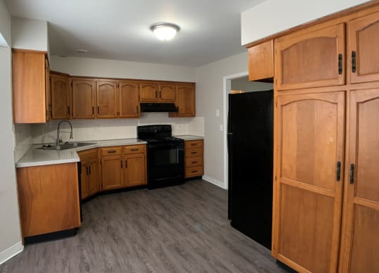 Kitchen with spacious wood cabinetry and black appliances