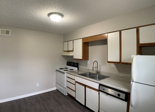 Full kitchen with spacious cabinetry and white appliances