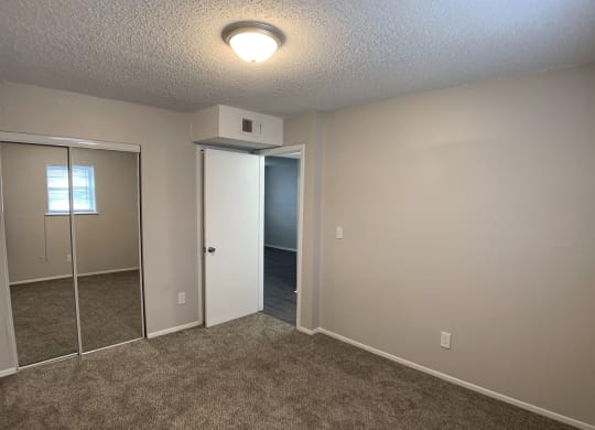 Spacious bedroom with mirrored closets