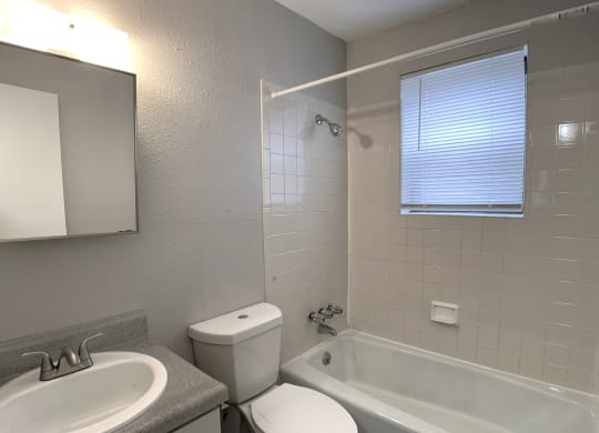 Full bathroom with tub and tiling