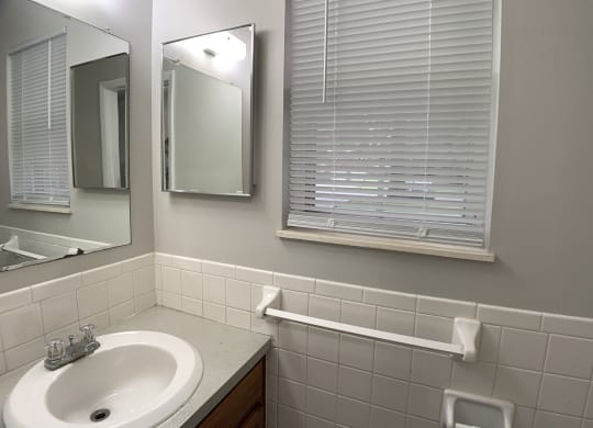 Bathroom with window and sink at Roosevelt in Independence, MO