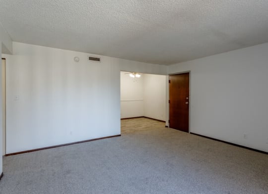 a bedroom with white walls and a carpeted floor