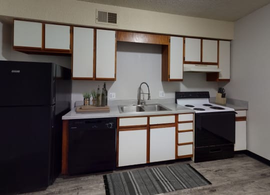 Kitchen with spacious cabinetry and black appliances