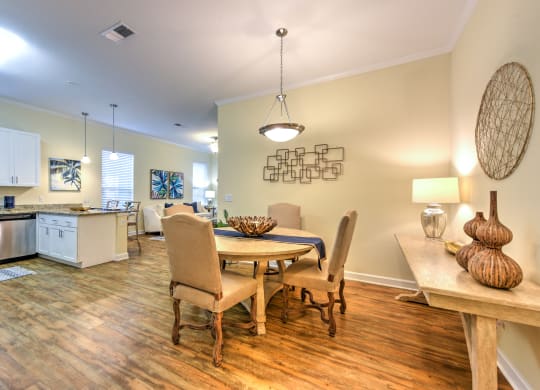 a dining area with a table and chairs and a kitchen in the background at Palm Bay Club, Jacksonville, FL