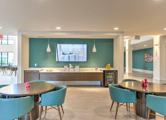a dining room with tables and chairs and a tv on the wall at Pinnacle Apartments, Florida, 32256