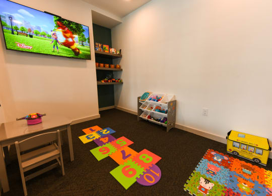 a childs play room with toys and a television at Pinnacle Apartments, Florida, 32256