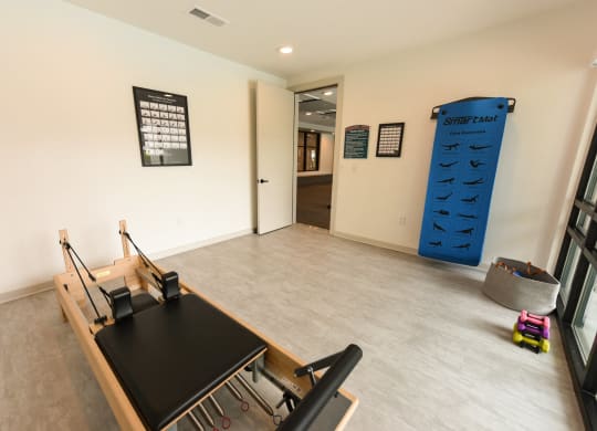 a room with a desk and a large blue climbing wall at Pinnacle Apartments, Florida, 32256