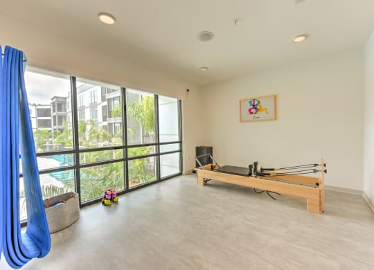 a room with a ping pong table and a large window at Pinnacle Apartments, Jacksonville, 32256