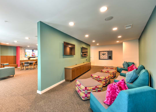 a living room with couches and chairs and a tv  at Pinnacle Apartments, Jacksonville
