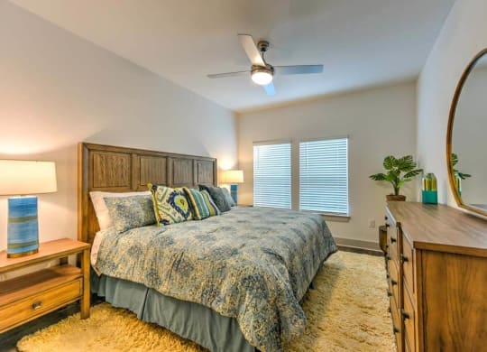 Bedroom with a Bed and Dresser at Fountainhead, Jacksonville, FL, 32258